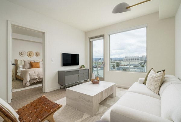 Modern living room with sleek furniture and large windows at Linea Apartments, offering luxury living in the heart of the city