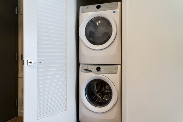 Laundry room with essential appliances at Linea Apartments, spacious and modern for convenient living