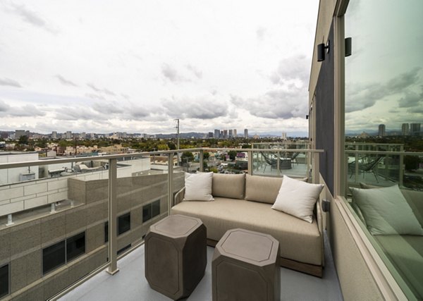Modern patio at Linea Apartments featuring comfortable seating and skyline views