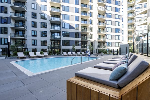 Rooftop pool with city skyline views at Linea Apartments