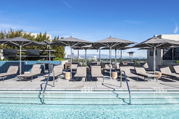 Modern infinity pool at Linea Apartments with sleek design and lounge chairs