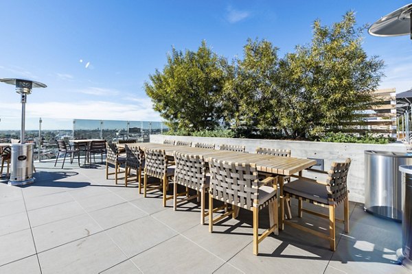 Rooftop deck with seating and skyline views at Linea Apartments