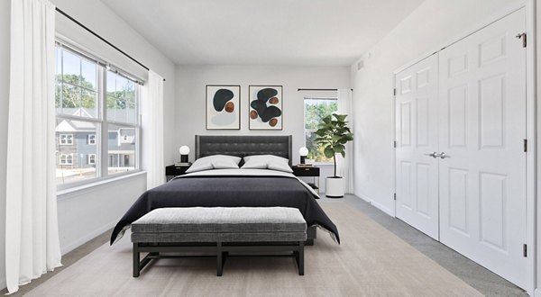 Cozy bedroom with elegant decor in The Cornerstone Hauppauge Apartments