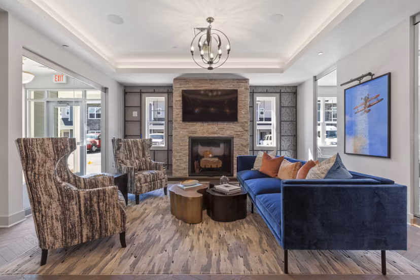 Clubhouse with modern dÃ©cor and cozy seating at The Cornerstone Hauppauge Apartments