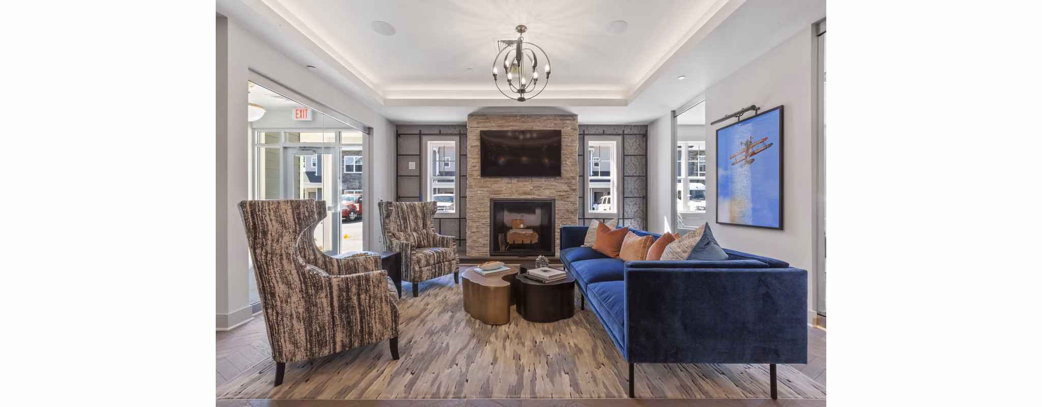 Clubhouse with modern dÃ©cor and cozy seating at The Cornerstone Hauppauge Apartments
