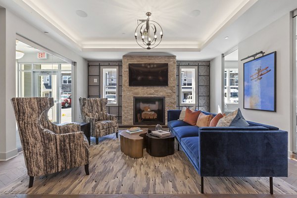 Clubhouse with modern dÃ©cor and cozy seating at The Cornerstone Hauppauge Apartments