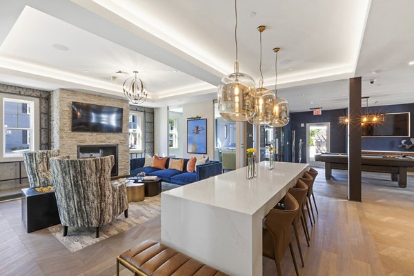 Clubhouse with modern decor and spacious seating at The Cornerstone Hauppauge Apartments