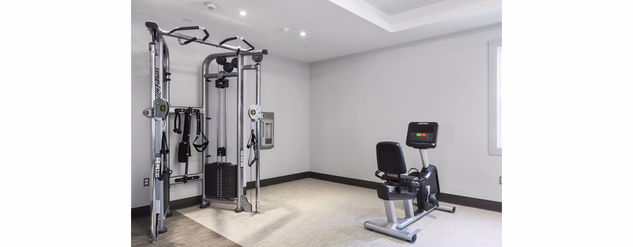 State-of-the-art fitness center at The Cornerstone Hauppauge Apartments with modern exercise equipment and spacious workout areas