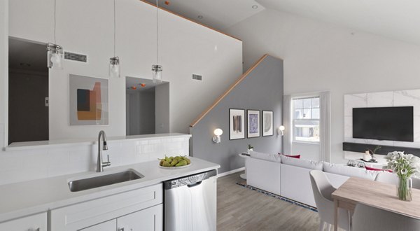 Modern kitchen with stainless steel appliances in The Cornerstone Hauppauge Apartments