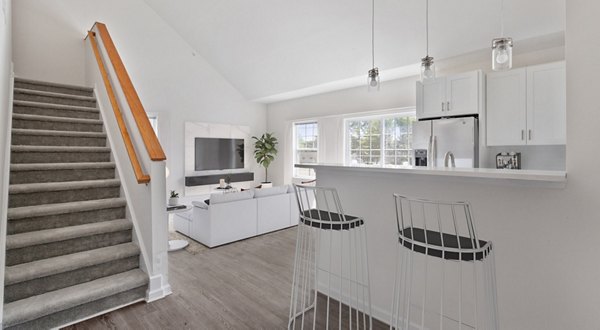 Modern kitchen with stainless steel appliances in The Cornerstone Hauppauge Apartments