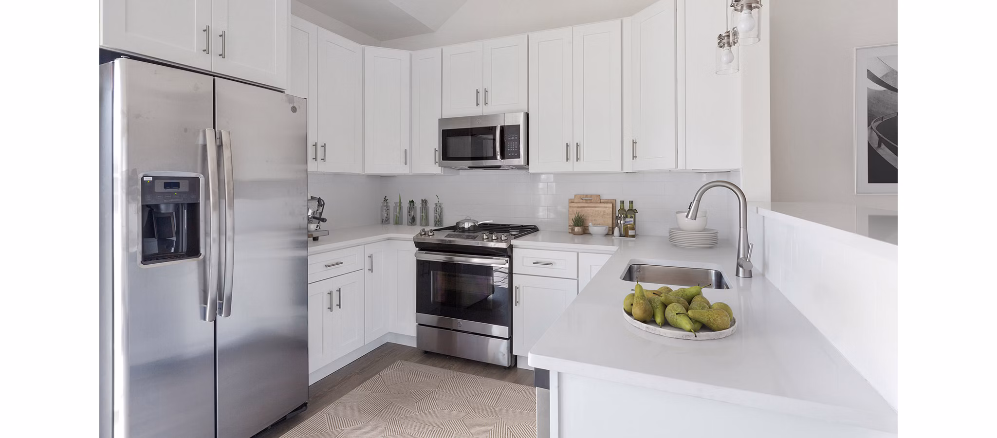 Modern kitchen with sleek appliances at The Cornerstone Hauppauge Apartments