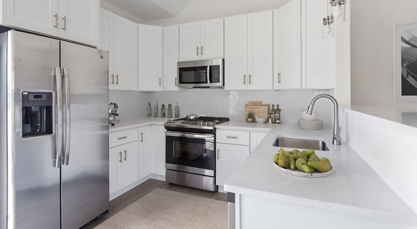 Modern kitchen with sleek appliances at The Cornerstone Hauppauge Apartments