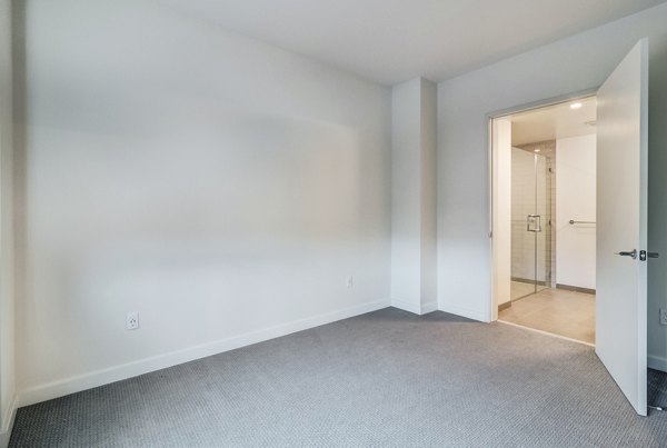Cozy bedroom with modern decor at 777 Tenn Apartments offering luxurious comforts in Nashville