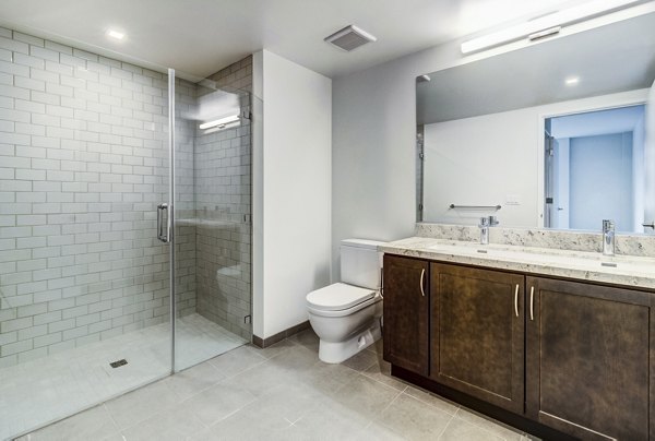 Modern bathroom with marble countertops at 777 Tenn Apartments
