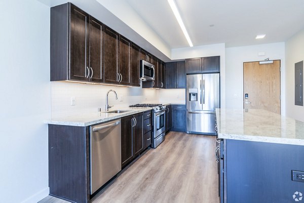 Modern kitchen with stainless steel appliances at 777 Tenn Apartments