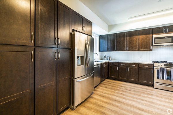 Modern kitchen with stainless steel appliances at 777 Tenn Apartments
