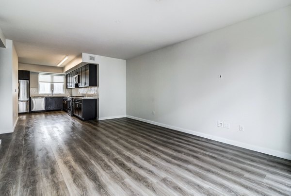 Living room with modern furnishings and large windows at 777 Tenn Apartments