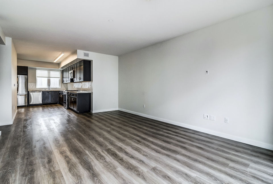 Living room with modern furnishings and large windows at 777 Tenn Apartments