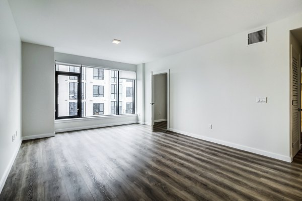 Living room with modern furnishings and large windows at 777 Tenn Apartments