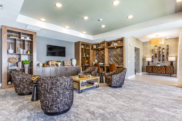 Overture Albuquerque: Chic clubhouse lobby with modern decor and seating areas, ideal for gatherings and relaxation at luxury apartments