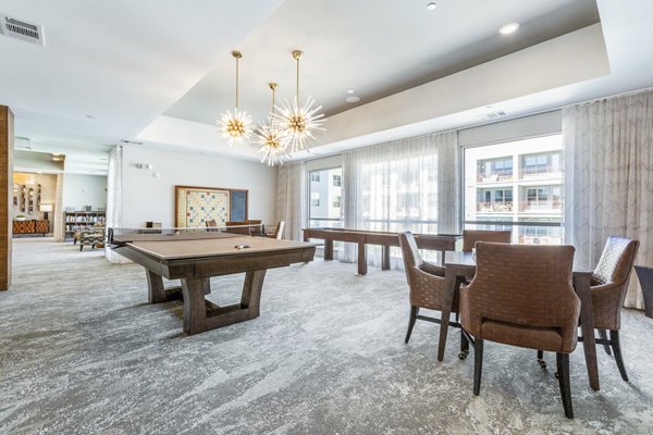 Game room with pool table and arcade games at Overture Albuquerque Apartments, ideal for leisure and entertainment