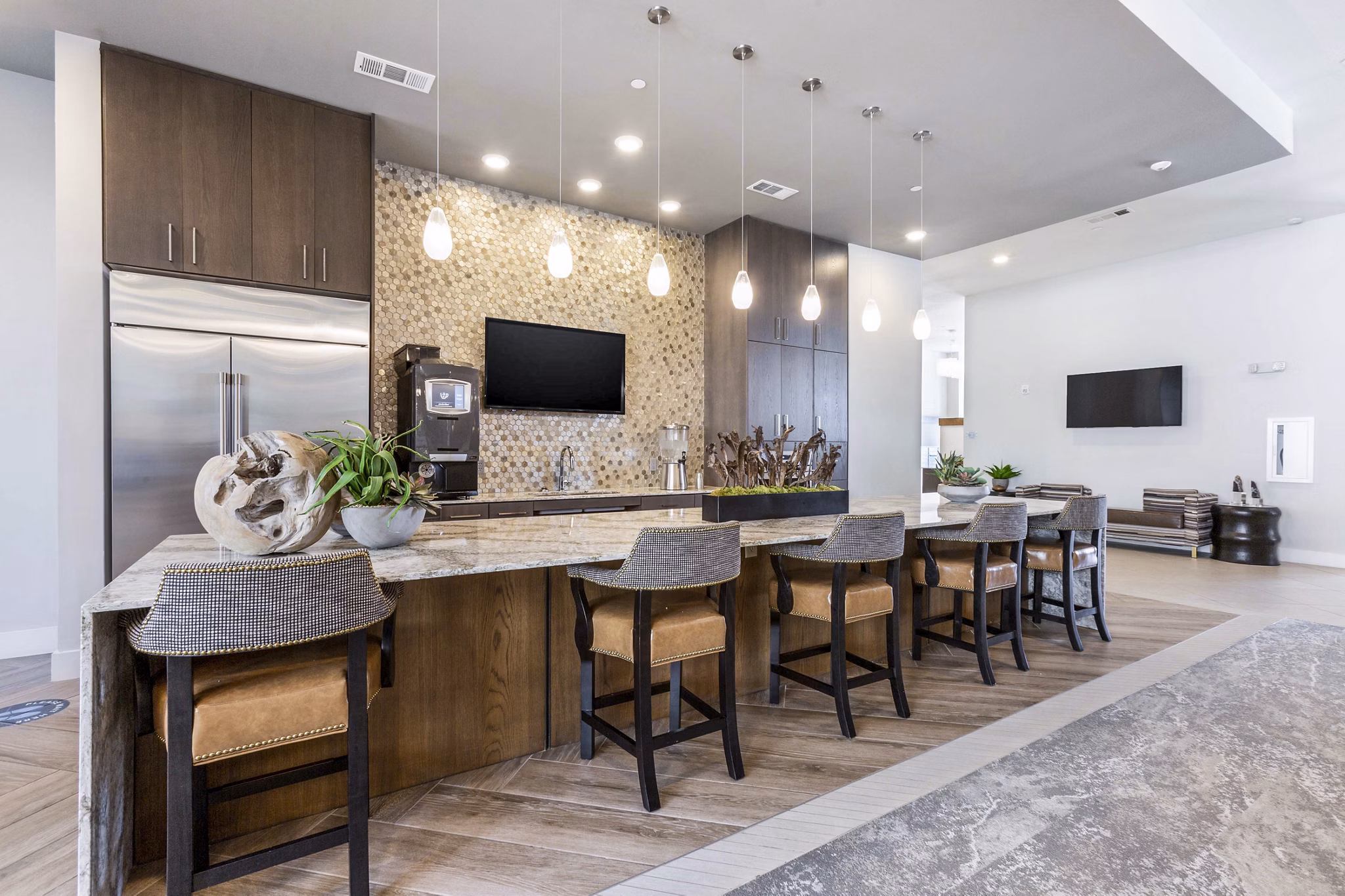Clubhouse kitchen with modern appliances and seating area at Overture Albuquerque Apartments
