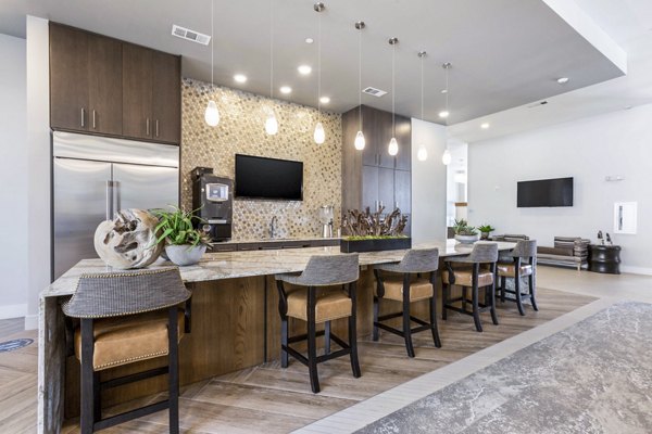 Clubhouse kitchen with modern appliances and seating area at Overture Albuquerque Apartments