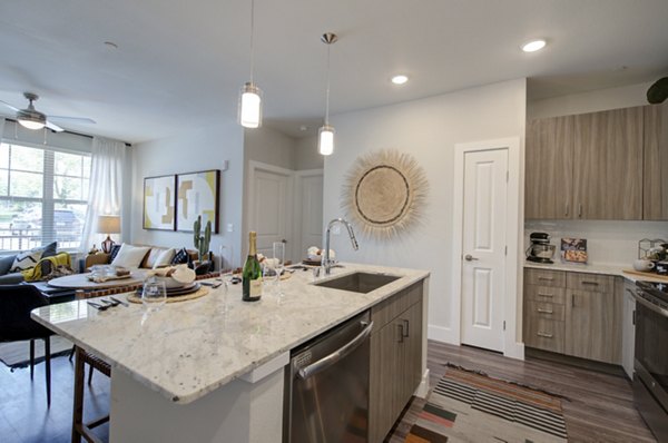Modern kitchen with stainless steel appliances at Overture Albuquerque Apartments
