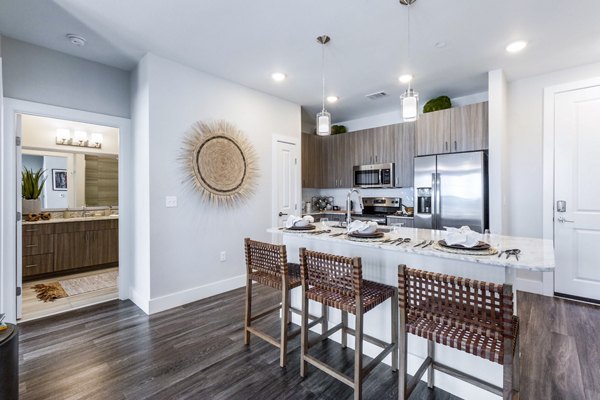 Modern kitchen with stainless steel appliances at Overture Albuquerque Apartments luxury living