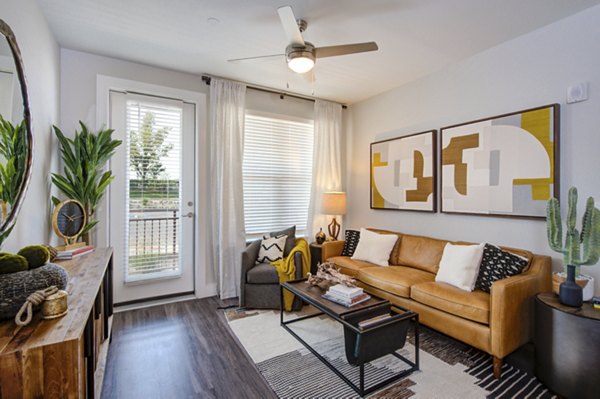 Spacious living room with modern decor in Overture Albuquerque Apartments, featuring comfortable seating and stylish design