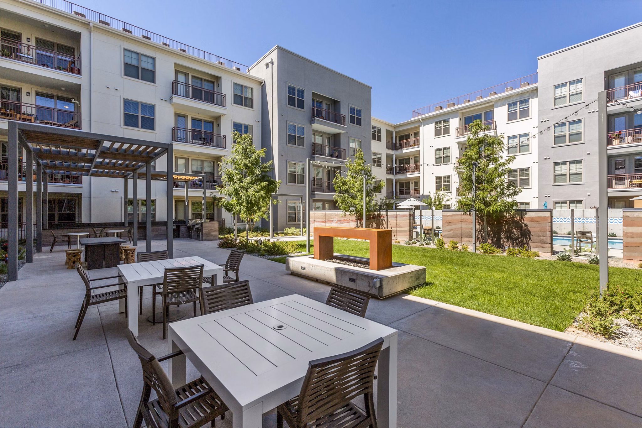 Outdoor grill area with fire pit on patio at Overture Albuquerque Apartments, perfect for entertaining and relaxation
