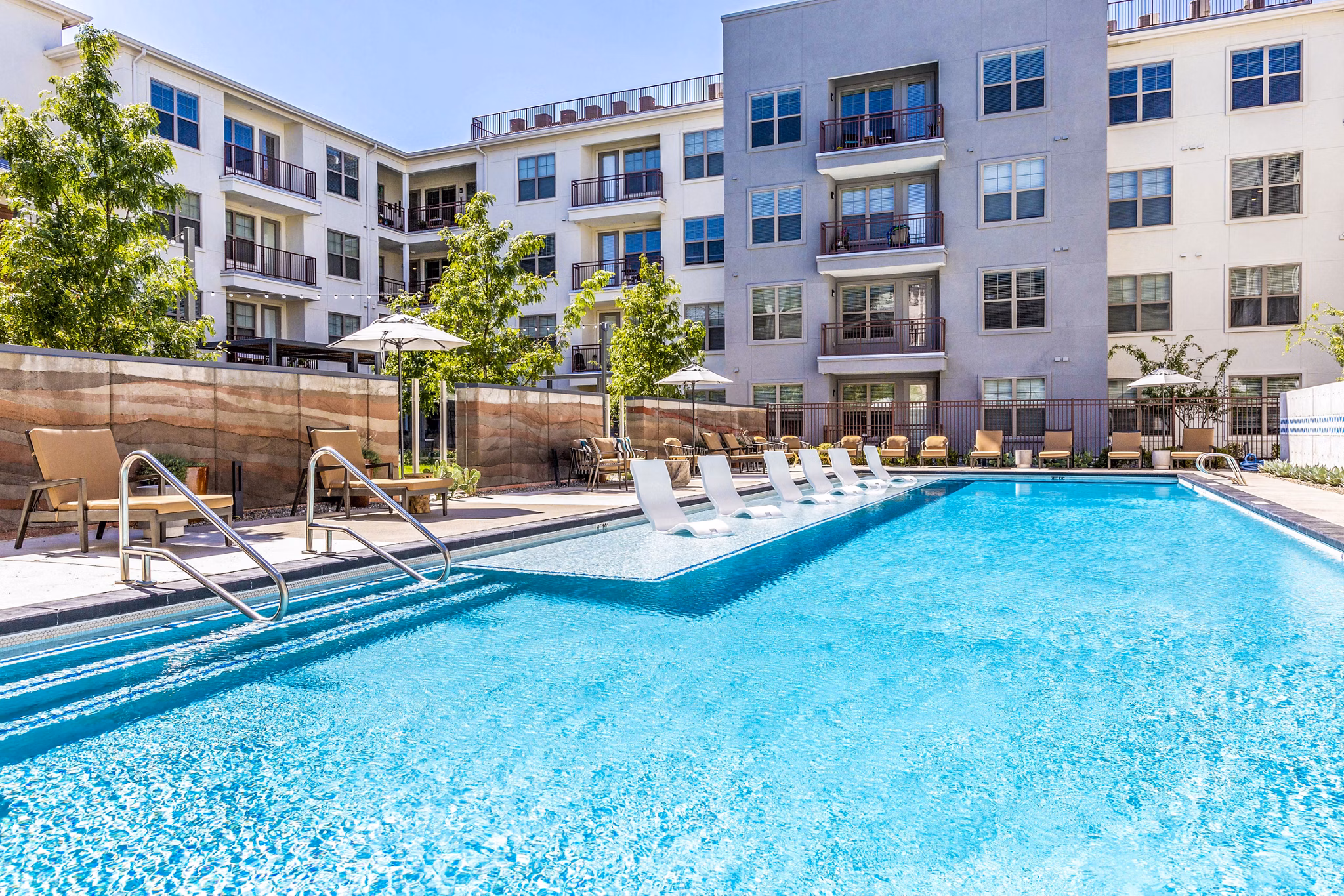 Rooftop pool with lounge seating at Overture Albuquerque Apartments, offering luxury amenities for residents