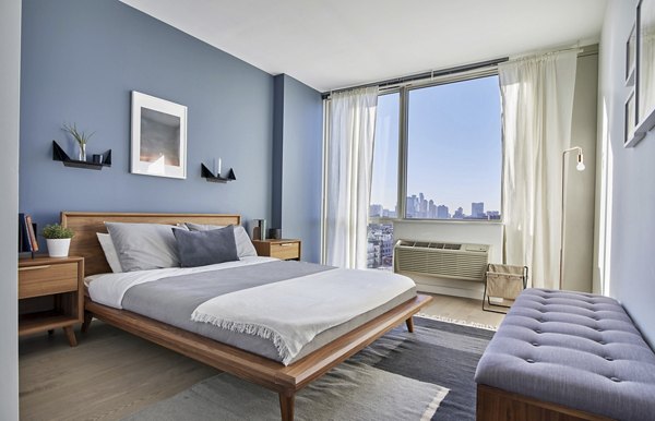 Cozy bedroom with modern decor at 7 Seventy House Apartments, offering luxury living spaces for comfort and relaxation