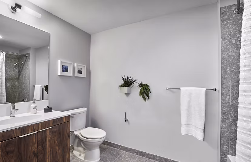 Bathroom with modern fixtures and marble countertops in 7 Seventy House Apartments