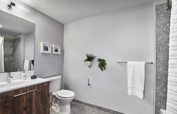 Bathroom with modern fixtures and marble countertops in 7 Seventy House Apartments