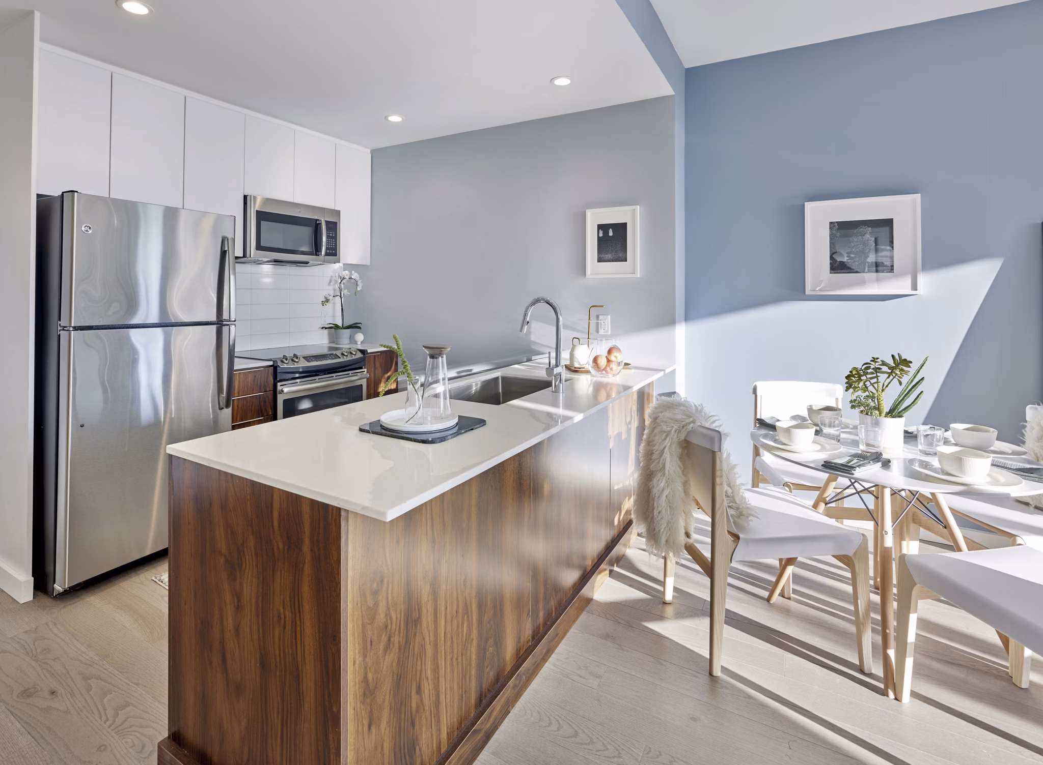 Modern kitchen featuring stainless steel appliances and sleek countertops at 7 Seventy House Apartments