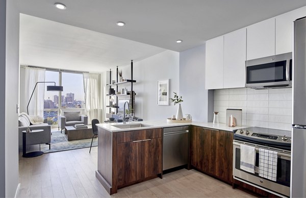 Modern kitchen with stainless steel appliances at 7 Seventy House Apartments, offering luxury living by Greystar in a vibrant community