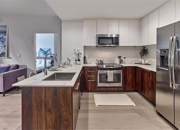 Modern kitchen with stainless steel appliances at 7 Seventy House Apartments, designed for luxury living in Hoboken