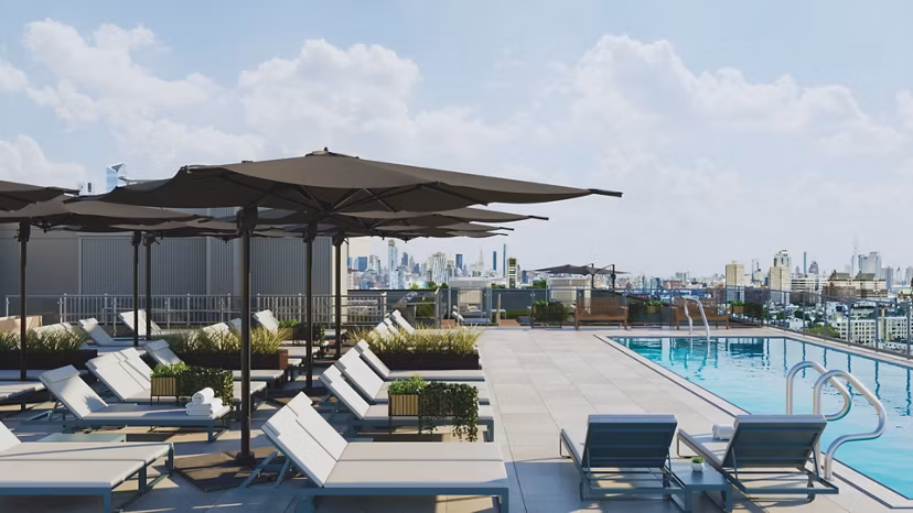 Modern pool with lounge chairs at 7 Seventy House Apartments, offering luxury amenities and relaxation spaces in a prime location