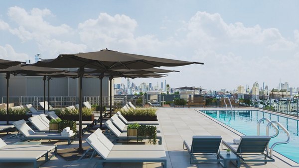 Modern pool with lounge chairs at 7 Seventy House Apartments, offering luxury amenities and relaxation spaces in a prime location