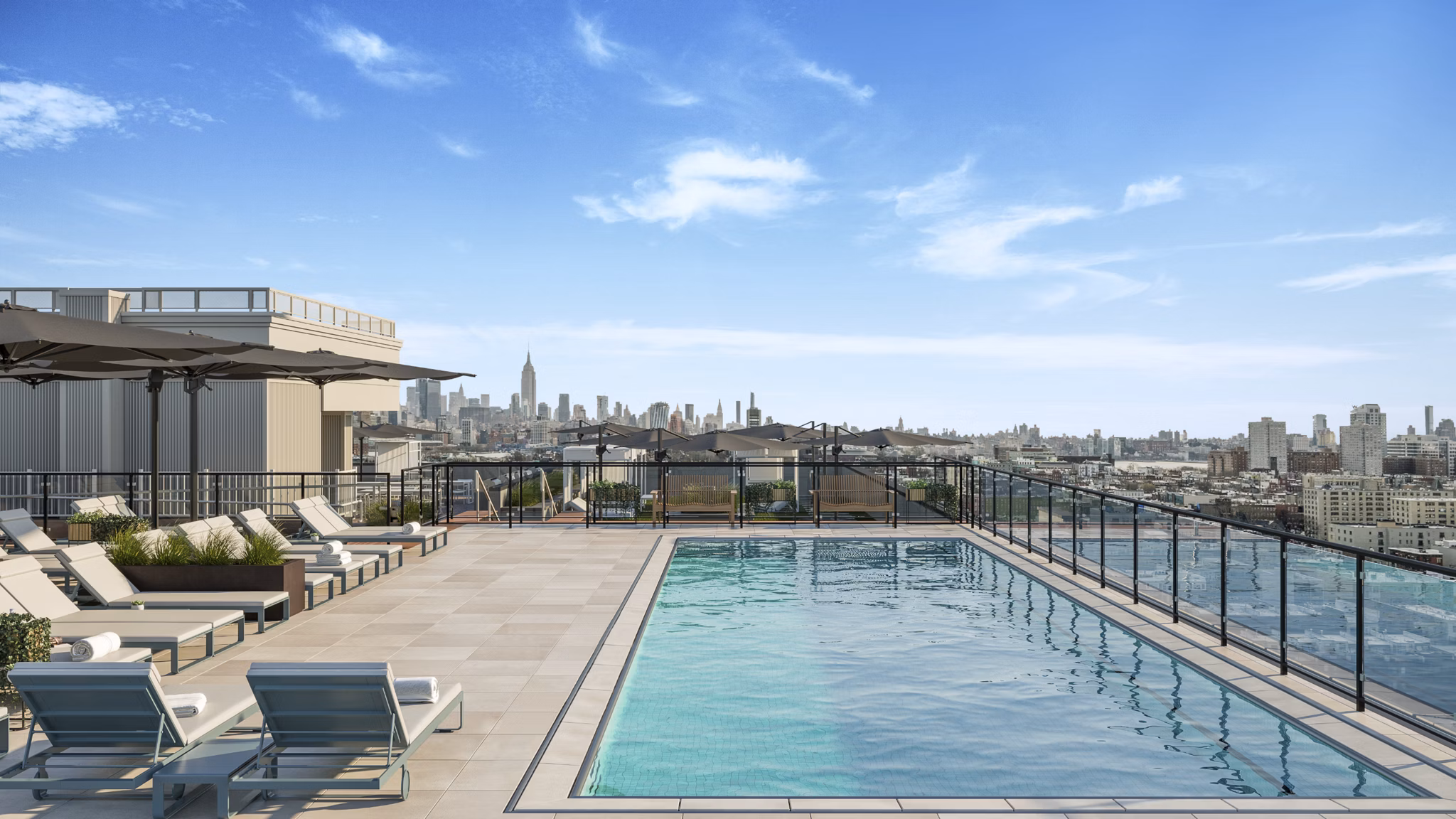 Resort-style pool with sundeck at 7 Seventy House Apartments, offering luxury living and relaxation