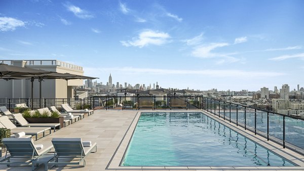 Resort-style pool with sundeck at 7 Seventy House Apartments, offering luxury living and relaxation