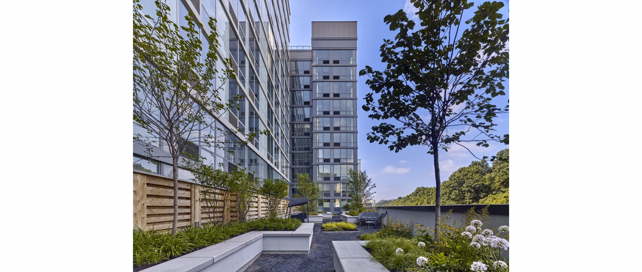 Inviting courtyard with lush greenery at 7 Seventy House Apartments, offering a serene outdoor retreat for residents in Hoboken