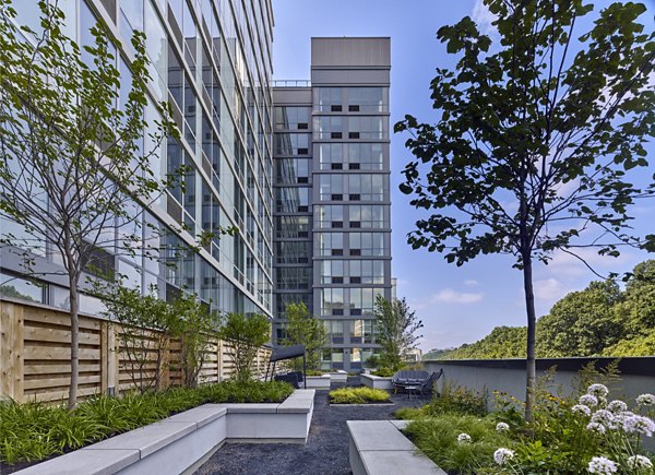 Inviting courtyard with lush greenery at 7 Seventy House Apartments, offering a serene outdoor retreat for residents in Hoboken