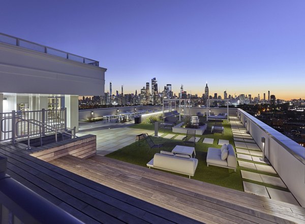 Panoramic city views from a rooftop deck at 7 Seventy House Apartments