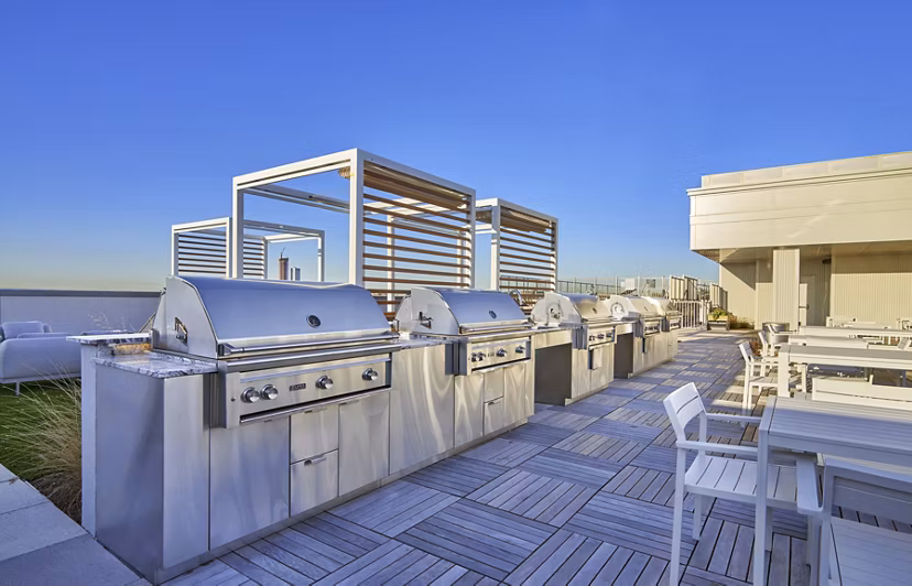 Grill area with modern outdoor seating at 7 Seventy House Apartments