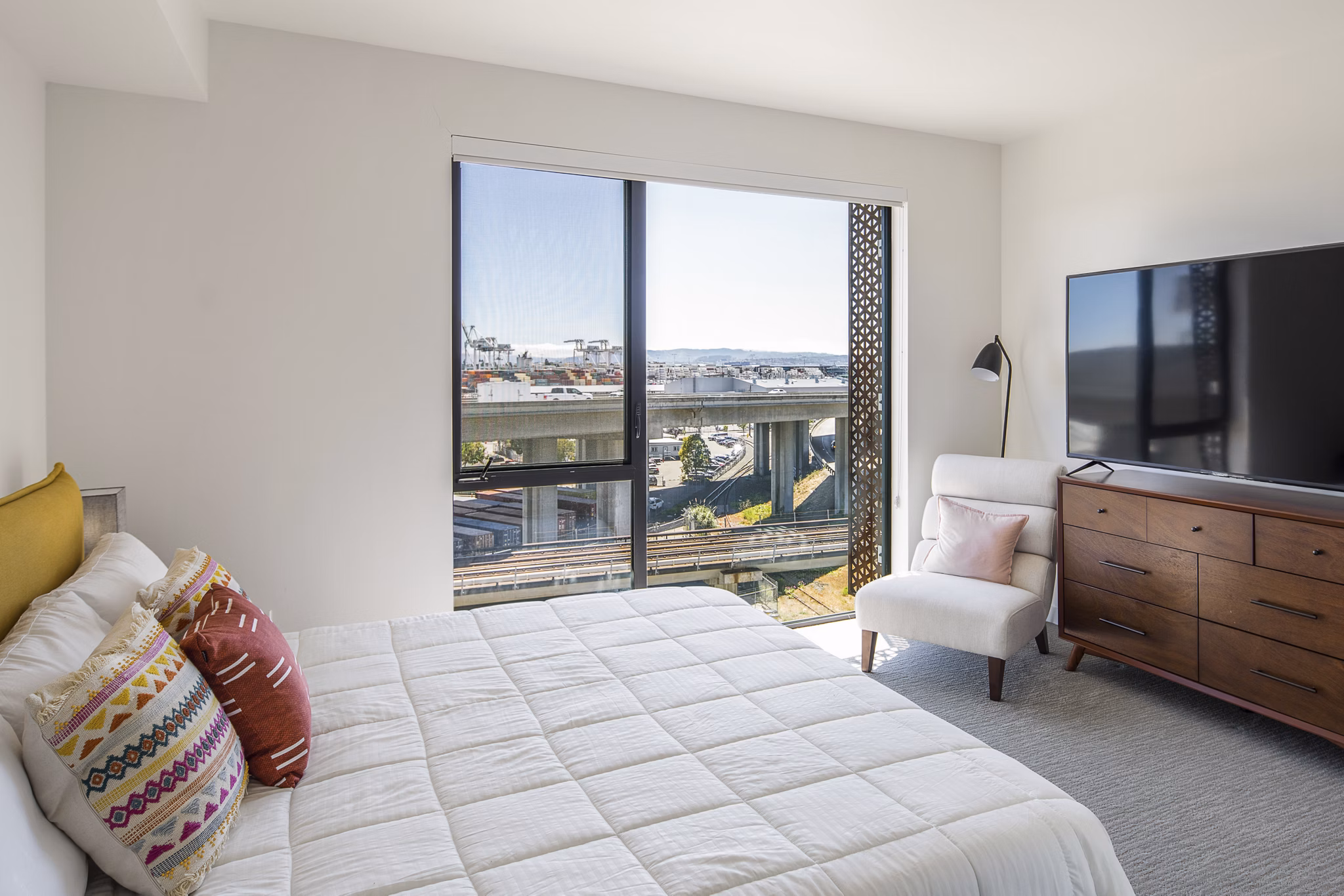 The Union Apartments: Cozy bedroom with elegant decor and ample natural light