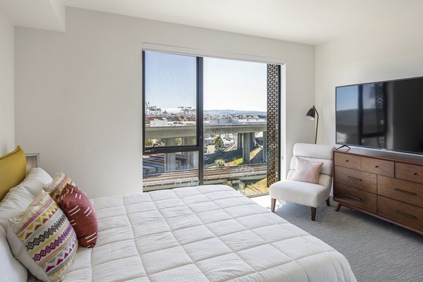The Union Apartments: Cozy bedroom with elegant decor and ample natural light