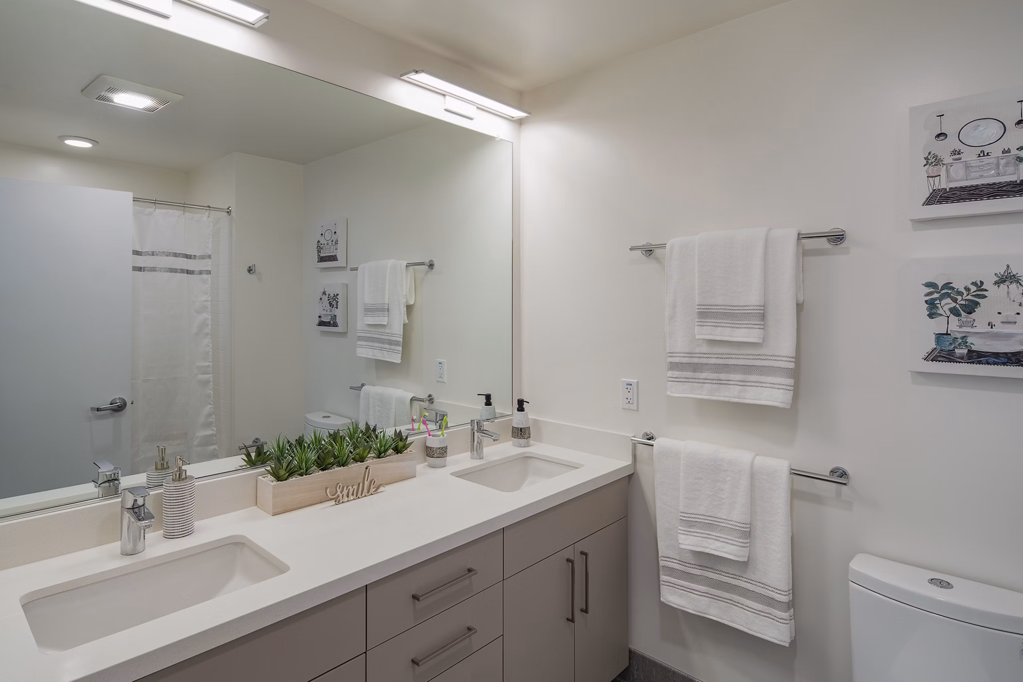 Bathroom featuring sleek marble countertops and modern fixtures at The Union Apartments