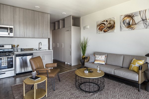 Spacious living room with modern decor at The Union Apartments, featuring comfortable seating and bright natural light